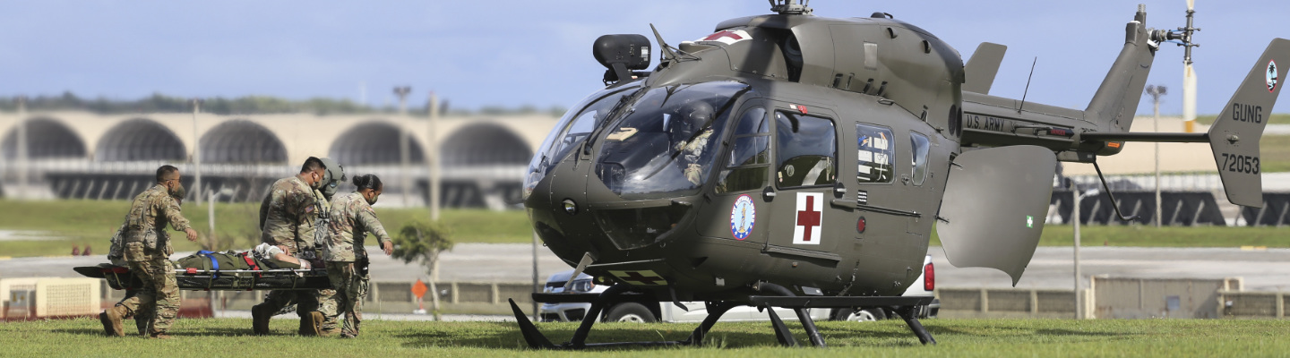 Soldiers from the Guam National Guard load a medical evacuation patient into a GUNG Lakota helicopter at Andersen Air Force Base on June 30.